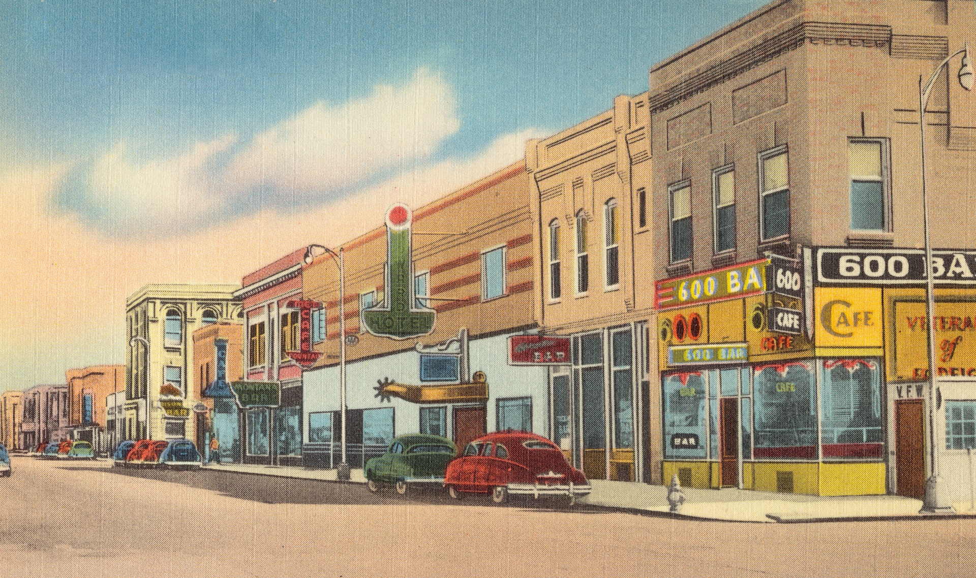 cars parked beside brown concrete building during daytime