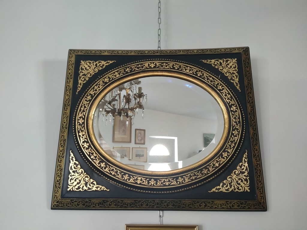 Miroir ovale cadre Napoléon III bois et stuc noirci motifs dorés